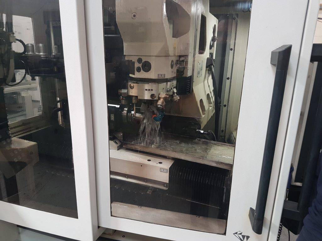 Erosion of a PCD tool in operation on one of our Vollmer QXD250 machines, showing how the machine uses fluid and copper wheels to sharpen our PCD tools
